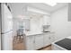 Bright eat-in kitchen features white cabinets, and stainless appliances at 200 St Andrews Blvd # 601, Winter Park, FL 32792