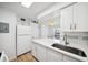 Open-concept kitchen with white cabinets, stainless steel appliances and a breakfast bar at 200 St Andrews Blvd # 601, Winter Park, FL 32792