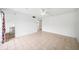 Bright living room with neutral tile flooring and a ceiling fan, offering a clean, modern space at 200 St Andrews Blvd # 601, Winter Park, FL 32792