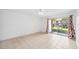 Bright living room with tile flooring and access to an outdoor patio at 200 St Andrews Blvd # 601, Winter Park, FL 32792