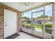 Screened-in patio featuring brick walls and a view of the community parking area at 200 St Andrews Blvd # 601, Winter Park, FL 32792