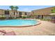 Community pool surrounded by lounge chairs, landscaped areas and condo buildings at 200 St Andrews Blvd # 601, Winter Park, FL 32792