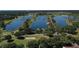 Expansive aerial view of a lake community with long winding waterways and lush greenery at 20130 Sunset Landing Ave, Groveland, FL 34736