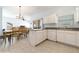 Modern kitchen with white cabinets, sleek countertops, and a seamless transition to the dining area at 20130 Sunset Landing Ave, Groveland, FL 34736