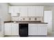 Kitchenette features white cabinetry, a countertop, and a mini fridge; perfect for convenience at 20130 Sunset Landing Ave, Groveland, FL 34736