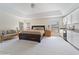 Spacious main bedroom featuring a sitting area, tray ceilings, and kitchenette with white cabinets at 20130 Sunset Landing Ave, Groveland, FL 34736