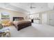 Large main bedroom features a kitchenette, seating, and tray ceilings for relaxed comfort at 20130 Sunset Landing Ave, Groveland, FL 34736