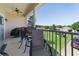 Covered patio showcasing a dining set and a view of the surrounding neighborhood and clear blue sky at 20130 Sunset Landing Ave, Groveland, FL 34736
