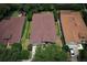 An aerial view of a well-maintained home, surrounded by trees and a neatly fenced backyard at 203 Brookgreen Way, Deland, FL 32724
