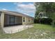 Backyard with brick patio and bench, adjoining the screened lanai at 203 Brookgreen Way, Deland, FL 32724