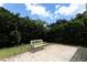 Backyard features a brick patio and bench, surrounded by mature trees at 203 Brookgreen Way, Deland, FL 32724