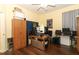 Bedroom with hardwood floors and plentiful workspace, including a closet and storage cabinet at 203 Brookgreen Way, Deland, FL 32724