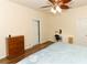 Cozy bedroom with wood-look flooring, ceiling fan, vanity, and a dresser at 203 Brookgreen Way, Deland, FL 32724