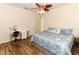 Bedroom with wood-look flooring and blue bedding at 203 Brookgreen Way, Deland, FL 32724