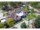 An aerial shot captures an opulent clubhouse with a distinctive metal roof, nestled within verdant landscaping at 203 Brookgreen Way, Deland, FL 32724