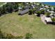 Aerial view showcasing a vast green space, playground, and community amenities, perfect for outdoor enjoyment at 203 Brookgreen Way, Deland, FL 32724