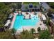 A refreshing community pool with sun loungers, umbrellas, and palm trees for a resort-style living experience at 203 Brookgreen Way, Deland, FL 32724