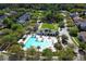 Aerial view of community pool showcasing poolside lounge areas and sun umbrellas, perfect for relaxation at 203 Brookgreen Way, Deland, FL 32724