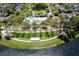 Aerial view of the community pool and clubhouse surrounded by lush landscaping and neighborhood homes at 203 Brookgreen Way, Deland, FL 32724
