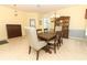 Open-concept dining room with tile floors, neutral colors, modern chandelier and a decorative hutch at 203 Brookgreen Way, Deland, FL 32724