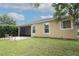 Exterior shot of a home with a screened-in porch and a brick patio at 203 Brookgreen Way, Deland, FL 32724