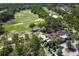 An aerial shot featuring the golf course and the charming clubhouse amidst the lush green landscape at 203 Brookgreen Way, Deland, FL 32724