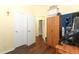 Hallway view with hardwood floors, closets, and multiple entryways to rooms at 203 Brookgreen Way, Deland, FL 32724