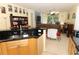 Bright eat-in kitchen featuring wood cabinets, black countertops, and stainless steel sink at 203 Brookgreen Way, Deland, FL 32724