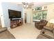 Spacious living room featuring a television, a sliding glass door, and a comfortable recliner set at 203 Brookgreen Way, Deland, FL 32724