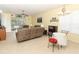 Cozy living room featuring a ceiling fan, tile floors, and sliding glass door access to patio at 203 Brookgreen Way, Deland, FL 32724