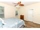 Bright main bedroom with wood floors, a ceiling fan, and a large window for ample light at 203 Brookgreen Way, Deland, FL 32724