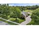 Aerial view showcases the home's manicured lawn, mature trees, and proximity to a serene pond at 205 Trail Bridge Ct, Winter Garden, FL 34787