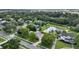 Neighborhood aerial showcasing property's location, mature trees, and proximity to a pond in a serene setting at 205 Trail Bridge Ct, Winter Garden, FL 34787