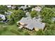 Spacious backyard, screened lanai, and meticulous landscaping in this elevated perspective of the home at 205 Trail Bridge Ct, Winter Garden, FL 34787