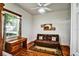 A bedroom with hardwood floors, a futon, a desk, and a window with blinds at 205 Trail Bridge Ct, Winter Garden, FL 34787