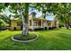 Charming home featuring a welcoming porch, lush lawn and mature landscaping at 205 Trail Bridge Ct, Winter Garden, FL 34787