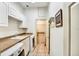 Bright laundry room with front load washer and dryer, tile floor, and storage at 205 Trail Bridge Ct, Winter Garden, FL 34787