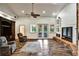Comfortable living room with vaulted ceilings, hardwood floors, brick fireplace, and French doors to the exterior at 205 Trail Bridge Ct, Winter Garden, FL 34787