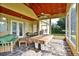 Relaxing screened patio with beautiful stone flooring, ceiling fan and comfortable seating area at 205 Trail Bridge Ct, Winter Garden, FL 34787