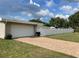 Exterior view of a house, showcasing the garage, brick driveway, and white fence at 229 Doverwood Rd, Fern Park, FL 32730