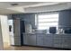 Well-lit kitchen featuring stainless steel appliances, neutral cabinets, and an undermount sink at 229 Doverwood Rd, Fern Park, FL 32730