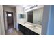 Bathroom with a double sink vanity and tile flooring, and a glass shower stall at 2355 Seven Oaks Dr, St Cloud, FL 34772