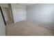 A clean and simple bedroom with neutral carpet, white walls, and a double closet, providing a serene space at 2355 Seven Oaks Dr, St Cloud, FL 34772