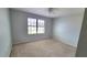 A bright and airy bedroom with a ceiling fan, neutral carpet, and a large window for natural light at 2355 Seven Oaks Dr, St Cloud, FL 34772