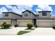 Attractive exterior of the townhome with beige paint, garage, and manicured landscaping at 2355 Seven Oaks Dr, St Cloud, FL 34772