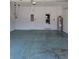 Spacious two car garage with painted floor and access door to the house at 2355 Seven Oaks Dr, St Cloud, FL 34772