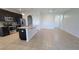 Kitchen featuring stainless steel appliances, dark cabinets, granite counters, and tile floors at 2355 Seven Oaks Dr, St Cloud, FL 34772