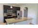 Kitchen featuring stainless steel appliances, granite countertops, dark cabinets, and a tile backsplash at 2355 Seven Oaks Dr, St Cloud, FL 34772