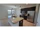 Modern kitchen with stainless steel appliances, granite countertops, and dark wood cabinets at 2355 Seven Oaks Dr, St Cloud, FL 34772