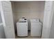 A practical laundry closet featuring a modern washing machine and dryer, complete with shelving at 2355 Seven Oaks Dr, St Cloud, FL 34772